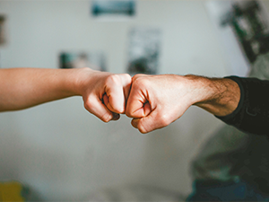 Business people fist bumping
